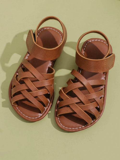 1 Pair Children's Brown Sandals, Solid Color PU Criss-Cross Woven Straps, Buckle Closure, Round Toe Open Toe Flat Non-Slip Fashion Cute Roman Sandals, Suitable For 3-12 Years Old Boys And Girls, Daily